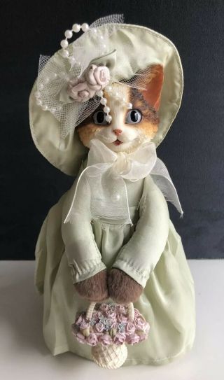 Artisan Flair Inc. ,  Cat In Green Dress And Bonnet Holding Ceramic Flower Basket