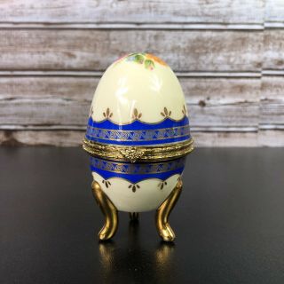Faberge Egg Hand Painted Gold And Navy Trim On Pedestal With Hinge To Open