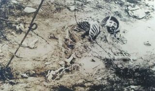 WWI RPPC Death German soldier skull skeleton helmet grenade trench war mud 3 2