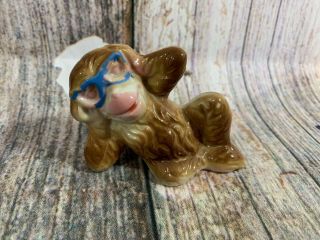 Vintage Japan Ceramic Brown Monkey Figurine Laying Down Wearing Blue Glasses