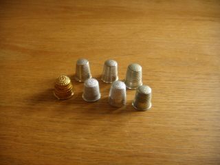 6 Vintage White Metal Sewing Thimbles,  A Collapsible Yellow Metal One.