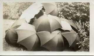 63322.  Vintage 1930s Photo Of Two Girls Hiding Inside Pile Of Rain Umbrellas