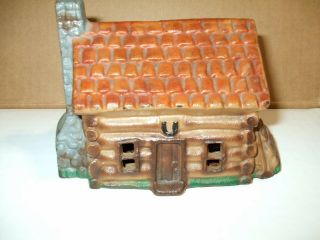 Vintage Log Cabin House Coin Piggy Bank Cast Iron Lid Painted 8”x 6”