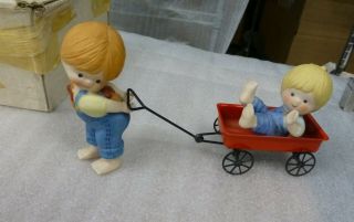 Enesco Country Cousins Girl Pulling Boy In Wagon And Boy On Sled