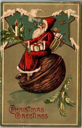 1907 Surreal Christmas Postcard Santa Claus Smoking Pipe Sitting On Giant Walnut