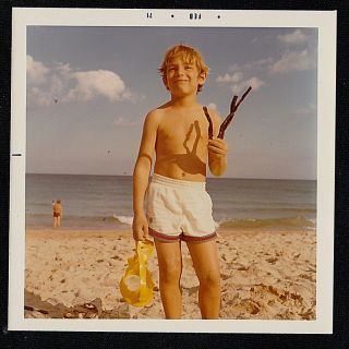 Vintage Photograph Little Boy With Sticks & Goggles Standing On The Beach