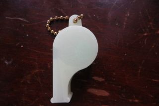 Old glow in the dark Edling Funeral Homes plastic whistle,  key chain,  advertise 3