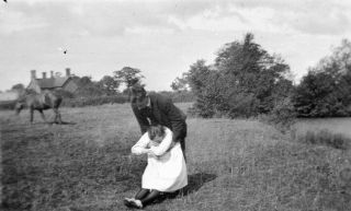 Vintage Negative.  Man Lifting Unconscious Woman In Field.  1910 