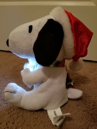 GEMMY PLUSH MUSICAL SNOOPY WITH SANTA HAT AND LIGHT UP SNOWFLAKE 7.  5 
