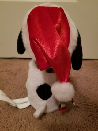 GEMMY PLUSH MUSICAL SNOOPY WITH SANTA HAT AND LIGHT UP SNOWFLAKE 7.  5 