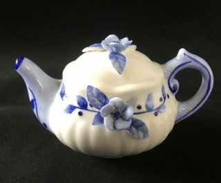 Miniature 2 1/4 " Blue & White Porcelain Teapot With Raised Floral Decoration