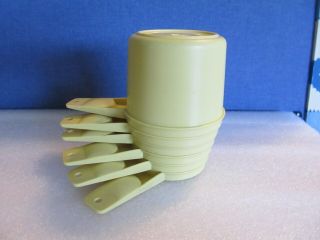 Tupperware yellow 6 piece measureing cups. 3