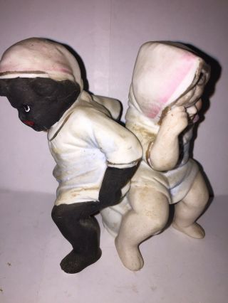 Bisque Figure Of A Black Boy And White Girl Sitting On The Same Chamber Pot.