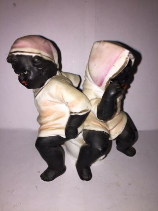 Bisque Figure Of A Black Boy And Black Girl Sitting On The Same Chamber Pot.