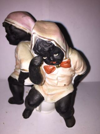 Bisque Figure Of A Black Boy And Black Girl Sitting On The Same Chamber Pot. 2