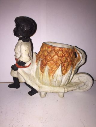 Bisque Figure Of A Black Man Pulling A Cart W/ Large Pineapple Cigarette Holder.