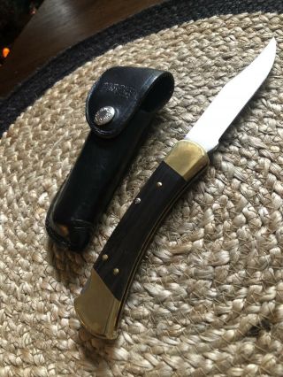 Buck 110 Folding Knife With Leather Sheath.